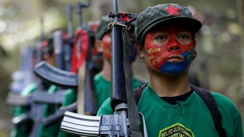 A photo taken on 23 November 2016, showing members of the New People's Army carrying guns.