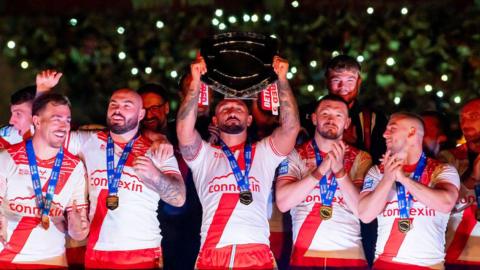 Hull Kingston Rovers captain Elliot Minchella lifts the League Leaders' Shield, surrounded by teammates