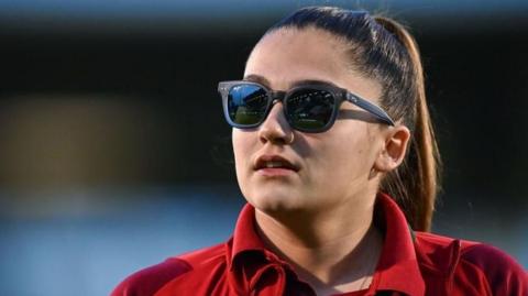 Safia Middleton-Patel looks to the left wearing sunglasses