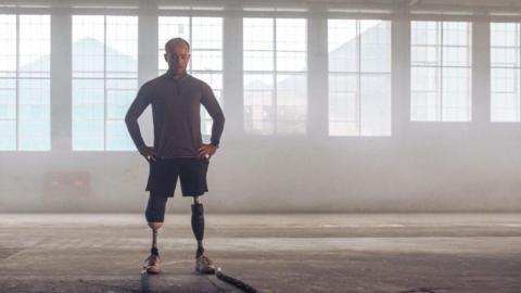 Billy Monger stood in an empty room as light pours in on him and he is sweating and staring at the ground intensely contemplating the challenge ahead