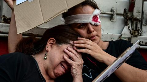 Demonstrators hold each other in Santiago during a protests against President Sebastián Piñera