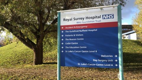 A sign directs people to the Royal Surrey Hospital in Guildford.