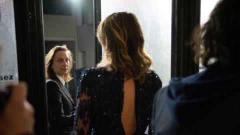 Céline Sciamma (C) and Adèle Haenel (R) leave the Salle Pleyel after the award for best director was given to Roman Polanski