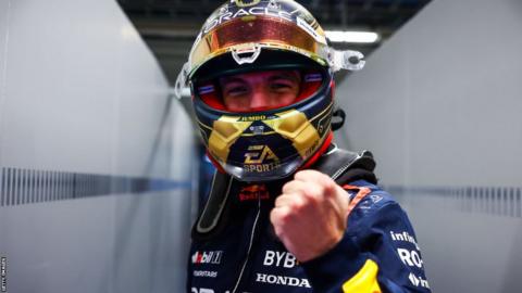 Red Bull's Max Verstappen clenches his fist in celebration and smiles at the camera after taking pole position for the Sao Paulo Grand Prix