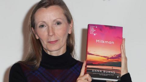 Anna Burns with a copy of her novel Milkman