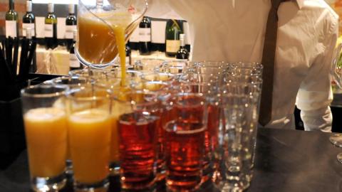 A man pouring drinks at a bar