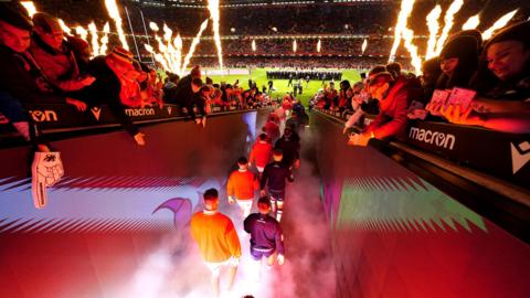 Rugby players enter the pitch for a Six Nations match in Cardiff