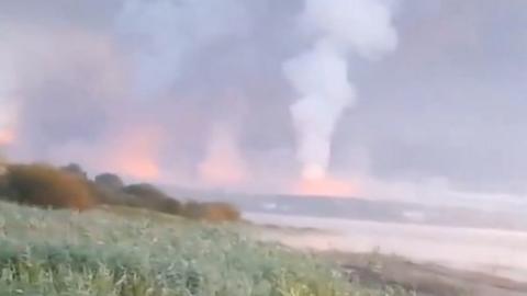 Smoke and flames rise following a Ukrainian drone attack in Toropets in the Tver region, Russia