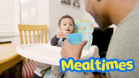 Baby and parent smiling together at mealtimes. 