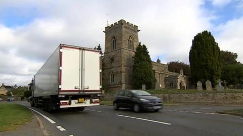 The centre of Isham with the parish church in the background