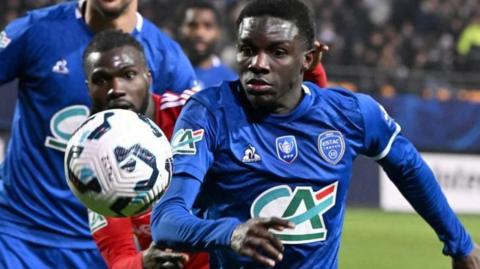 Abdoulaye Kante challenges for the ball during a match