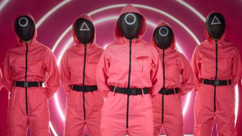 Squid Game 'VIPs' in pink boiler suits and masks