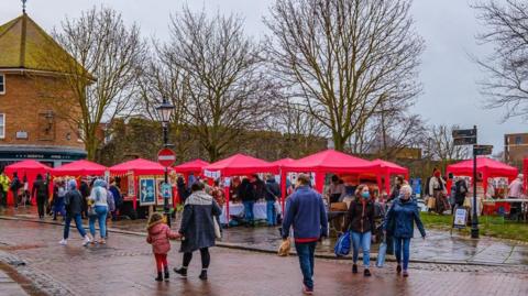 Visitors attending the monthly Rochester City Artisan Market in Kent. There are a variety of stalls.