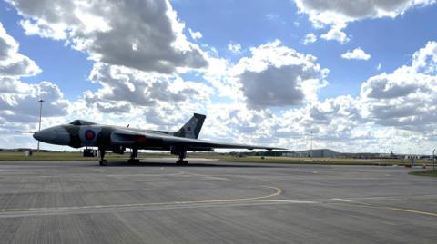 A plane is parked on the runway of a deserted airport