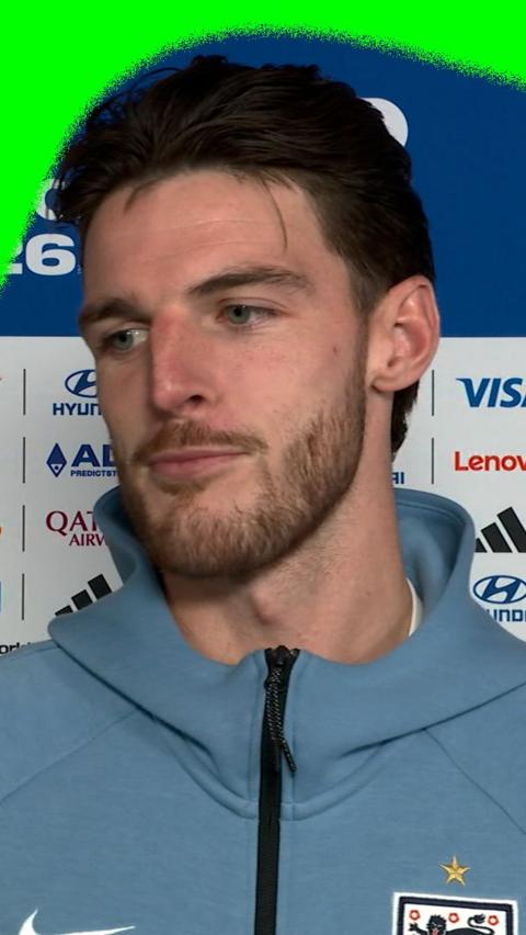 Declan Rice against a blue backdrop in a pre-match interview ahead of England v Argentina in the 2026 World Cup semi-finals