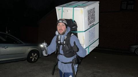 man carrying fridge