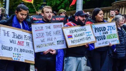 Pro-Jewish supporters hold placards during the Pro-Jewish Rally organised by the Christian led "Never Again Is Now" movement to stand against hate and antisemitism and to support Jewish community. 