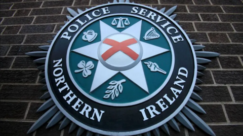 PSNI badge on wall