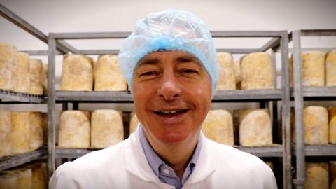 Long Clawson Dairy's Kim Kettle stands in front of cheeses