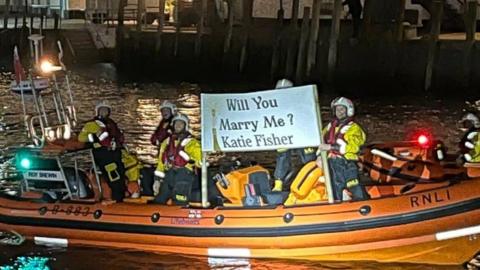 Looe RNLI with proposal banner