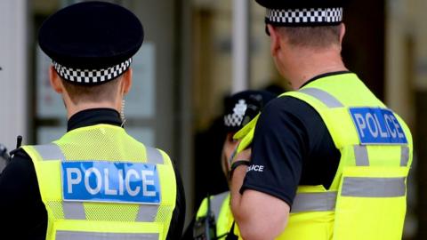 View looking towards the back of two male police officers