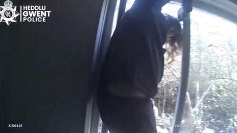 man jumping out of window 