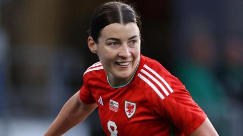 Angharad James celebrates scoring for Wales