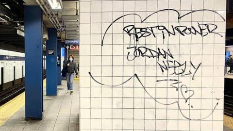 Graffiti reading, "rest in power, Jordan Neely" scrawled in the station where police responded to the incident.