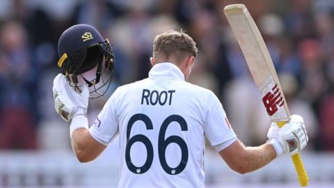 An image from behind Joe Root as he celebrates reaching his century