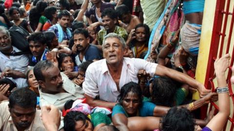 Indian devotees gather after a stampede at a religious festival in Godavari in the Rajahmundry district some 200 kms north-east of Hyderabad on July 14, 2015.