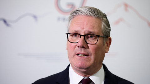 Sir Keir Starmer at the G7 summit in Evian France. He is wearing glasses, a dark suit, a white shirt and a tie.