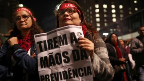 Demonstrators protest against President Jair Bolsonaro's proposed pension reform project in Sao Paulo, Brazil, July 10, 2019. The sign reads "Take your hands off the pension".