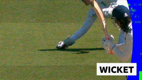 Amy Jones taking a diving catch 