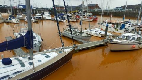 The orange coloured water in Whitehaven Harbour