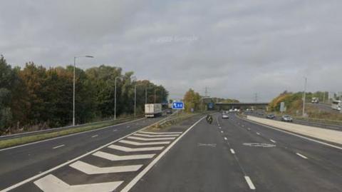 Junction 12 of the M4 - a lorry can be seen heading off at the exit for the A4 while several other vehicles are driving on the main carriageway