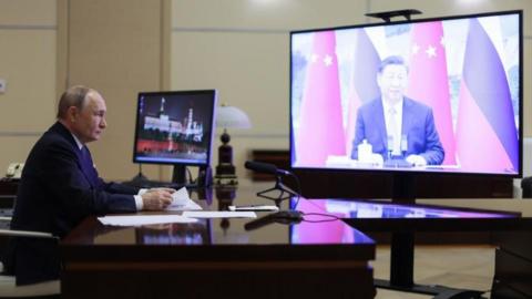 Russian President Vladimir Putin holds a meeting with Chinese President Xi Jinping (on screen) via video conference at the Novo-Ogaryovo state residence, outside Moscow, Russia, 21 January 2025.