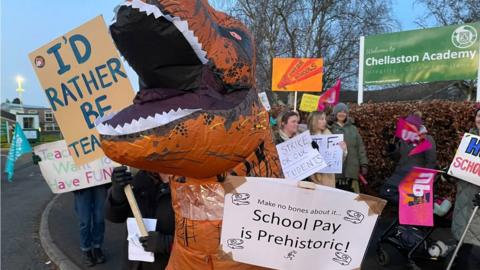 Teacher dressed as dinosaur on picket line