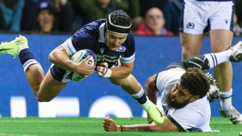 Scotland's Darcy Graham (left) crosses for a try