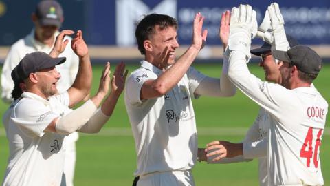 Glamorgan players high-five in celebration
