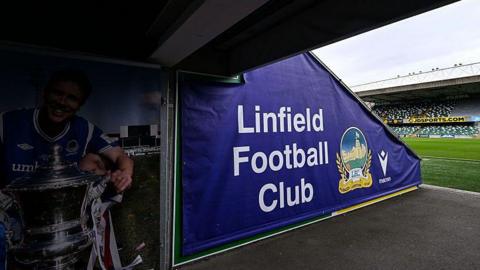 A blue sign in Windsor Park that says Linfield Football Club