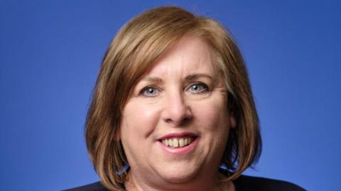 Fiona, a woman with short light brown hair