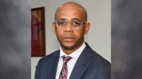 A head and shoulders image of Baltasar Ebang Engonga wearing a blue suit, white shirt and patterned tie.