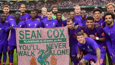 Liverpool players and Jurgen Klopp manager of Liverpool hold a banner for Sean Cox the Liverpool fan who has recently awoken from a coma after being injured at a Liverpool match at the end of the pre season friendly match between Liverpool and Napoli