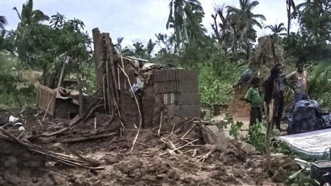 A family in a village in Cabo Delgado province cook a meal surrounded by their destroyed home, 17 April 2019