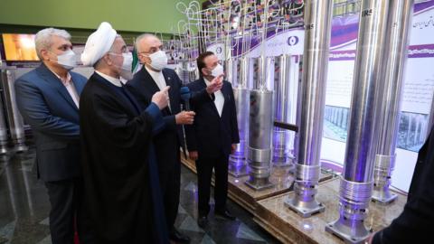 Iranian President Hassan Rouhani (L) and head of the Atomic Energy Organization of Iran Ali Akbar Salehi (2nd R) visit a nuclear technology exhibition in Tehran, Iran (10 April 2021)