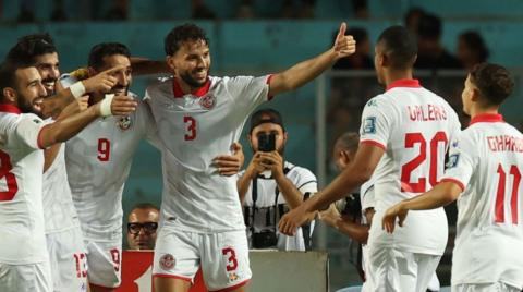 Tunisia players celebrate a goal
