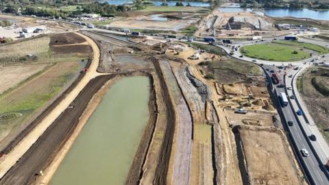 A view of the road from a drone shows the black cat roundabout and construction work around it