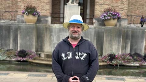 A man standing in front of Bristol's City Hall
