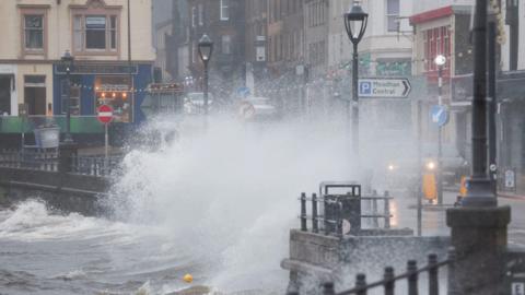 Waves overtop a promenade in Scotland in strong winds