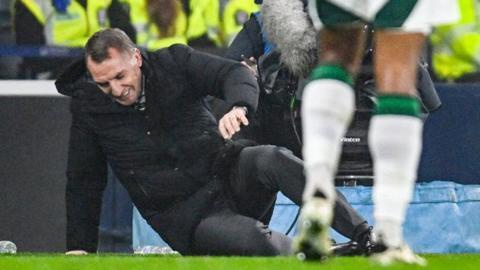 Brendan Rodgers lying on the Hampden turf